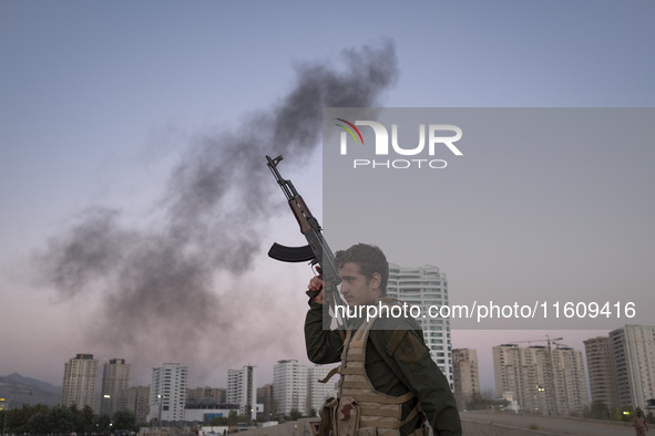 A member of the Islamic Revolutionary Guard Corps (IRGC) takes part in a war game, which is a reconstruction of the Valfajr-8 military opera...