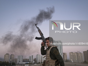 A member of the Islamic Revolutionary Guard Corps (IRGC) takes part in a war game, which is a reconstruction of the Valfajr-8 military opera...