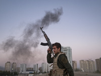 A member of the Islamic Revolutionary Guard Corps (IRGC) takes part in a war game, which is a reconstruction of the Valfajr-8 military opera...