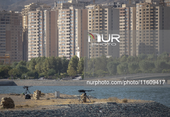 Two machine guns are placed in an area near housing complexes during the reconstruction of the Valfajr-8 military operation, commemorating t...