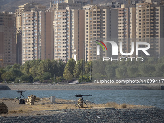 Two machine guns are placed in an area near housing complexes during the reconstruction of the Valfajr-8 military operation, commemorating t...