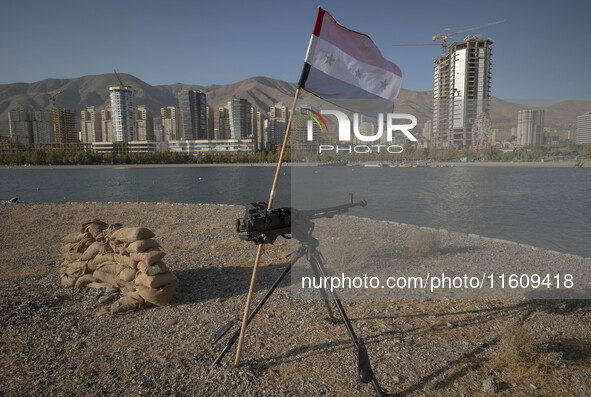 A machine gun and an Iraqi flag are placed in an area near housing complexes during the reconstruction of the Valfajr-8 military operation,...