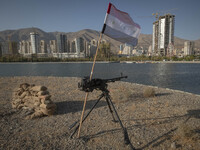 A machine gun and an Iraqi flag are placed in an area near housing complexes during the reconstruction of the Valfajr-8 military operation,...