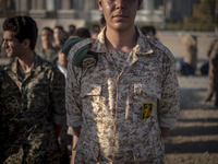 An Islamic Revolutionary Guard Corps (IRGC) military personnel stands at attention during the reconstruction of the Valfajr-8 military opera...