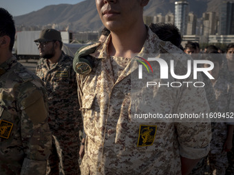 Islamic Revolutionary Guard Corps (IRGC) military personnel stand at attention during the reconstruction of the Valfajr-8 military operation...