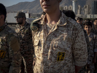 Islamic Revolutionary Guard Corps (IRGC) military personnel stand at attention during the reconstruction of the Valfajr-8 military operation...