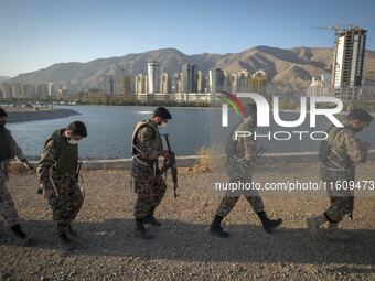 Islamic Revolutionary Guard Corps (IRGC) military personnel walk along an area during a war-game, which is a reconstruction of the Valfajr-8...