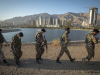 Islamic Revolutionary Guard Corps (IRGC) military personnel walk along an area during a war-game, which is a reconstruction of the Valfajr-8...