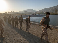 Islamic Revolutionary Guard Corps (IRGC) military personnel walk along an area during a war-game, which is a reconstruction of the Valfajr-8...