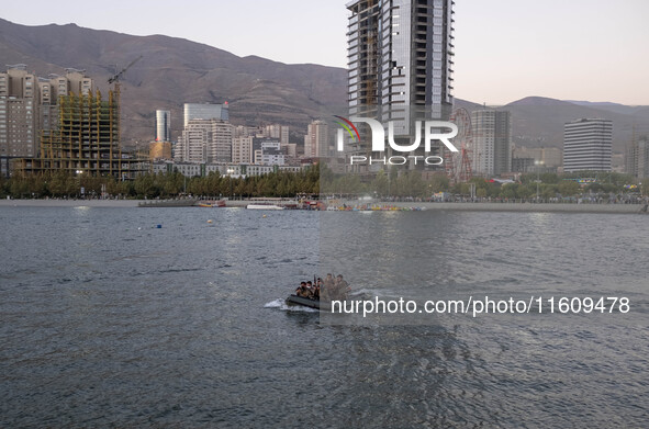 Islamic Revolutionary Guard Corps (IRGC) military personnel sail a speedboat in a lake during a war game that reconstructs the Valfajr-8 mil...