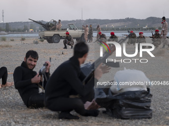 Islamic Revolutionary Guard Corps (IRGC) military personnel take part in a war game, which is a reconstruction of the Valfajr-8 military ope...