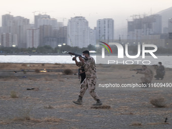 An Islamic Revolutionary Guard Corps (IRGC) military personnel takes part in a war game, which is a reconstruction of the Valfajr-8 military...