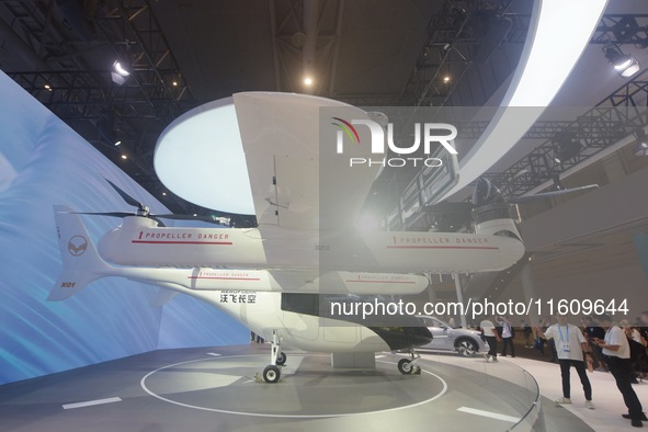 Visitors view the AE200 tilt-rotor electric vertical Take-off and Landing aircraft (eVTOL) at the Global Digital Trade Expo in Hangzhou, Chi...