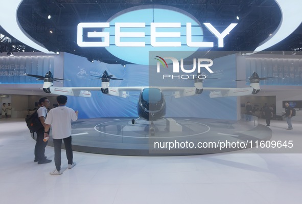 Visitors view the AE200 tilt-rotor electric vertical Take-off and Landing aircraft (eVTOL) at the Global Digital Trade Expo in Hangzhou, Chi...