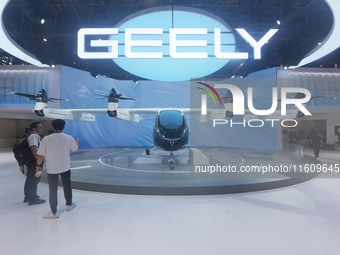 Visitors view the AE200 tilt-rotor electric vertical Take-off and Landing aircraft (eVTOL) at the Global Digital Trade Expo in Hangzhou, Chi...