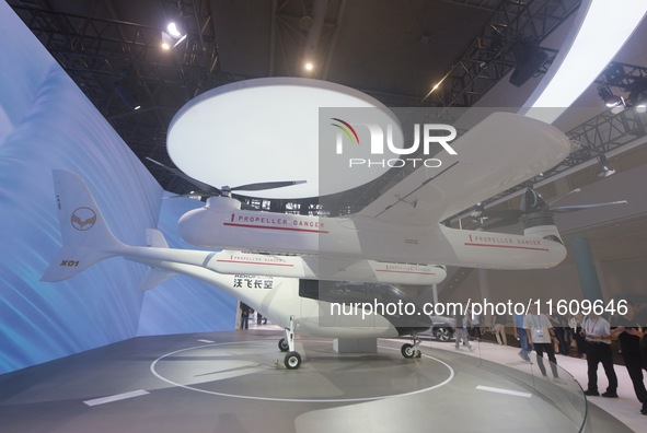 Visitors view the AE200 tilt-rotor electric vertical Take-off and Landing aircraft (eVTOL) at the Global Digital Trade Expo in Hangzhou, Chi...