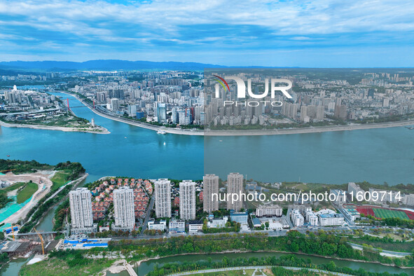 An aerial view shows high-rise buildings lining the riverside city, half landscape and half city, in Yichang, Hubei, China, on September 21,...