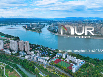 An aerial view shows high-rise buildings lining the riverside city, half landscape and half city, in Yichang, Hubei, China, on September 21,...