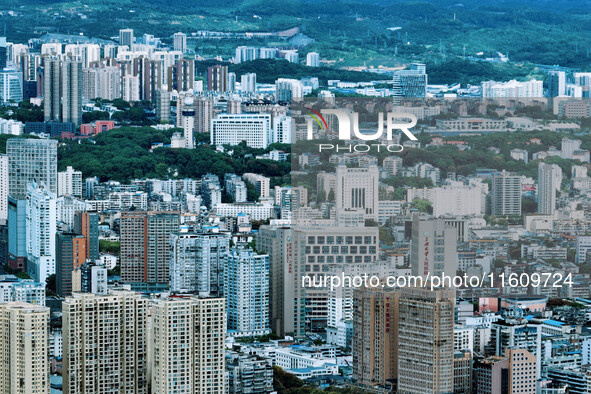 An aerial view shows high-rise buildings lining the riverside city in Yichang, Hubei, China, on September 21, 2024. 