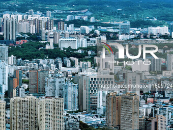 An aerial view shows high-rise buildings lining the riverside city in Yichang, Hubei, China, on September 21, 2024. (