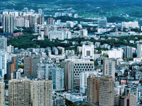 An aerial view shows high-rise buildings lining the riverside city in Yichang, Hubei, China, on September 21, 2024. (