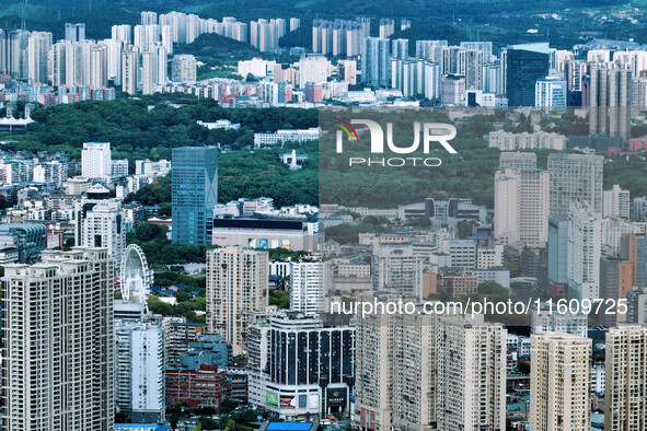 An aerial view shows high-rise buildings lining the riverside city in Yichang, Hubei, China, on September 21, 2024. 