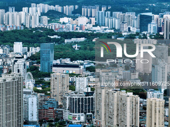 An aerial view shows high-rise buildings lining the riverside city in Yichang, Hubei, China, on September 21, 2024. (