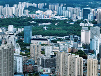 An aerial view shows high-rise buildings lining the riverside city in Yichang, Hubei, China, on September 21, 2024. (