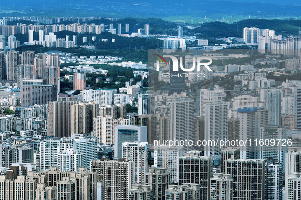 An aerial view shows high-rise buildings lining the riverside city in Yichang, Hubei, China, on September 21, 2024. 