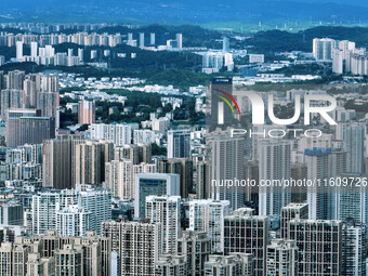 An aerial view shows high-rise buildings lining the riverside city in Yichang, Hubei, China, on September 21, 2024. (