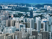 An aerial view shows high-rise buildings lining the riverside city in Yichang, Hubei, China, on September 21, 2024. (