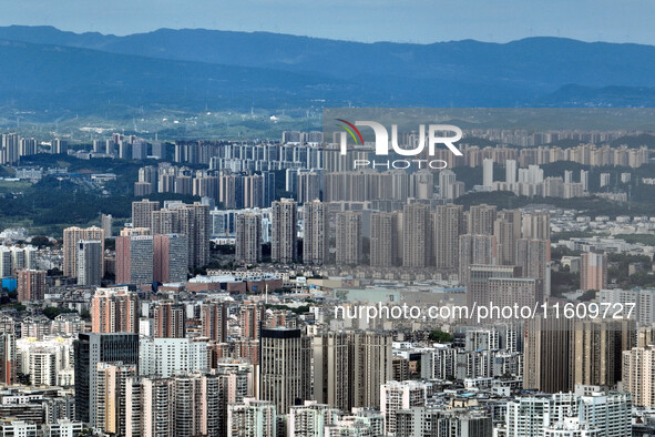 An aerial view shows high-rise buildings lining the riverside city in Yichang, Hubei, China, on September 21, 2024. 