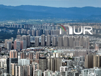 An aerial view shows high-rise buildings lining the riverside city in Yichang, Hubei, China, on September 21, 2024. (