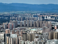 An aerial view shows high-rise buildings lining the riverside city in Yichang, Hubei, China, on September 21, 2024. (