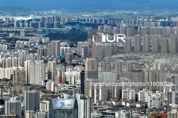 An aerial view shows high-rise buildings lining the riverside city in Yichang, Hubei, China, on September 21, 2024. 