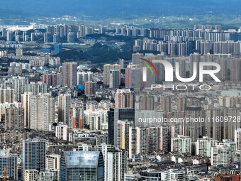 An aerial view shows high-rise buildings lining the riverside city in Yichang, Hubei, China, on September 21, 2024. (