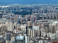 An aerial view shows high-rise buildings lining the riverside city in Yichang, Hubei, China, on September 21, 2024. (