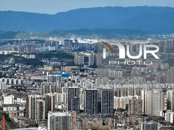 An aerial view shows high-rise buildings lining the riverside city in Yichang, Hubei, China, on September 21, 2024. (