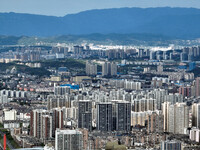 An aerial view shows high-rise buildings lining the riverside city in Yichang, Hubei, China, on September 21, 2024. (