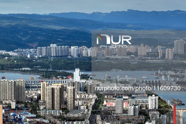 An aerial view shows high-rise buildings lining the riverside city in Yichang, Hubei, China, on September 21, 2024. 