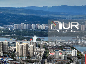 An aerial view shows high-rise buildings lining the riverside city in Yichang, Hubei, China, on September 21, 2024. (