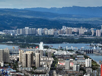 An aerial view shows high-rise buildings lining the riverside city in Yichang, Hubei, China, on September 21, 2024. (