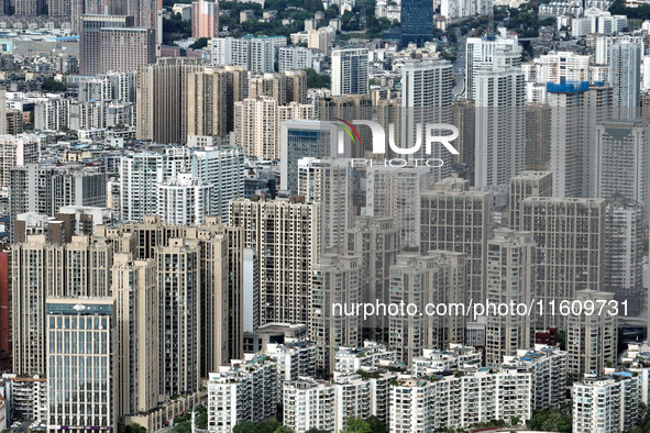 An aerial view shows high-rise buildings lining the riverside city in Yichang, Hubei, China, on September 21, 2024. 