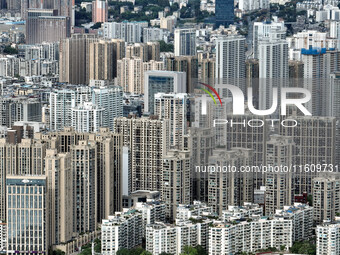 An aerial view shows high-rise buildings lining the riverside city in Yichang, Hubei, China, on September 21, 2024. (