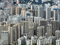 An aerial view shows high-rise buildings lining the riverside city in Yichang, Hubei, China, on September 21, 2024. (