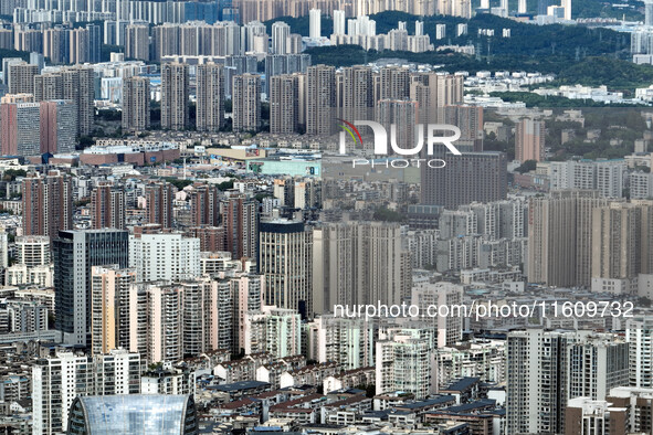 An aerial view shows high-rise buildings lining the riverside city in Yichang, Hubei, China, on September 21, 2024. 