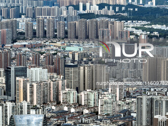 An aerial view shows high-rise buildings lining the riverside city in Yichang, Hubei, China, on September 21, 2024. (