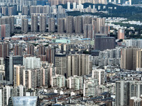 An aerial view shows high-rise buildings lining the riverside city in Yichang, Hubei, China, on September 21, 2024. (