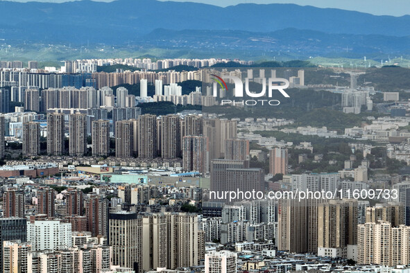 An aerial view shows high-rise buildings lining the riverside city in Yichang, Hubei, China, on September 21, 2024. 