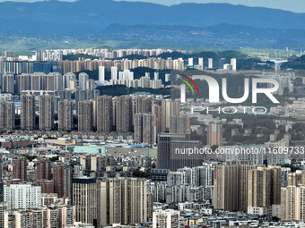 An aerial view shows high-rise buildings lining the riverside city in Yichang, Hubei, China, on September 21, 2024. (